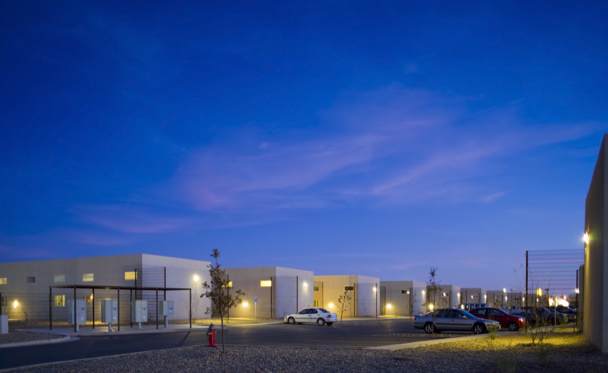 Wide evening view of the Lolomas community in Clovis with lit homes under a violet sky